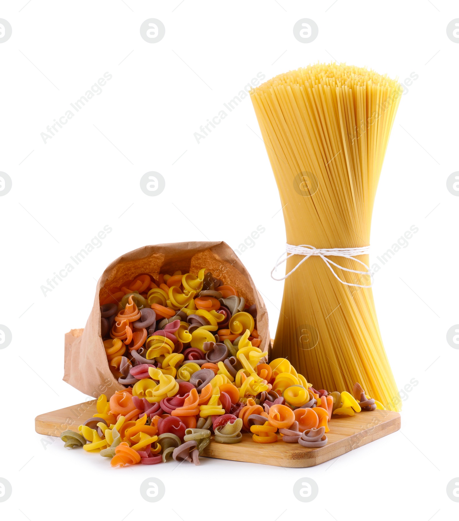 Photo of Wooden board with spaghetti and colorful insalatonde pasta isolated on white