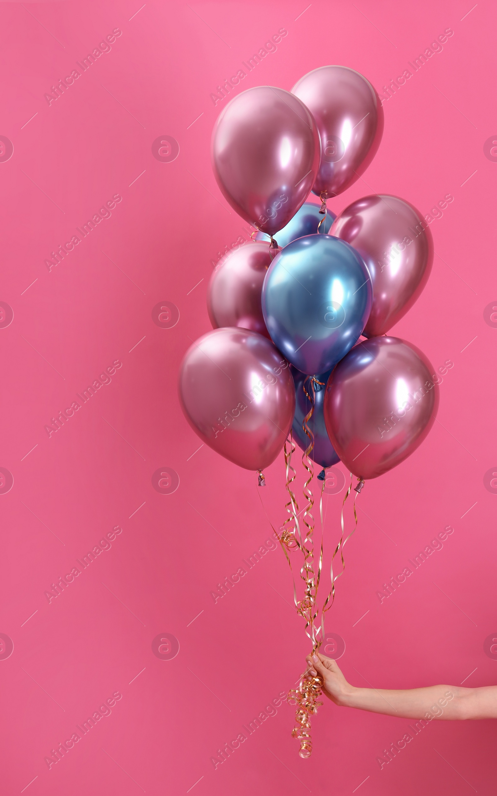 Photo of Woman holding bunch of balloons on color background, closeup