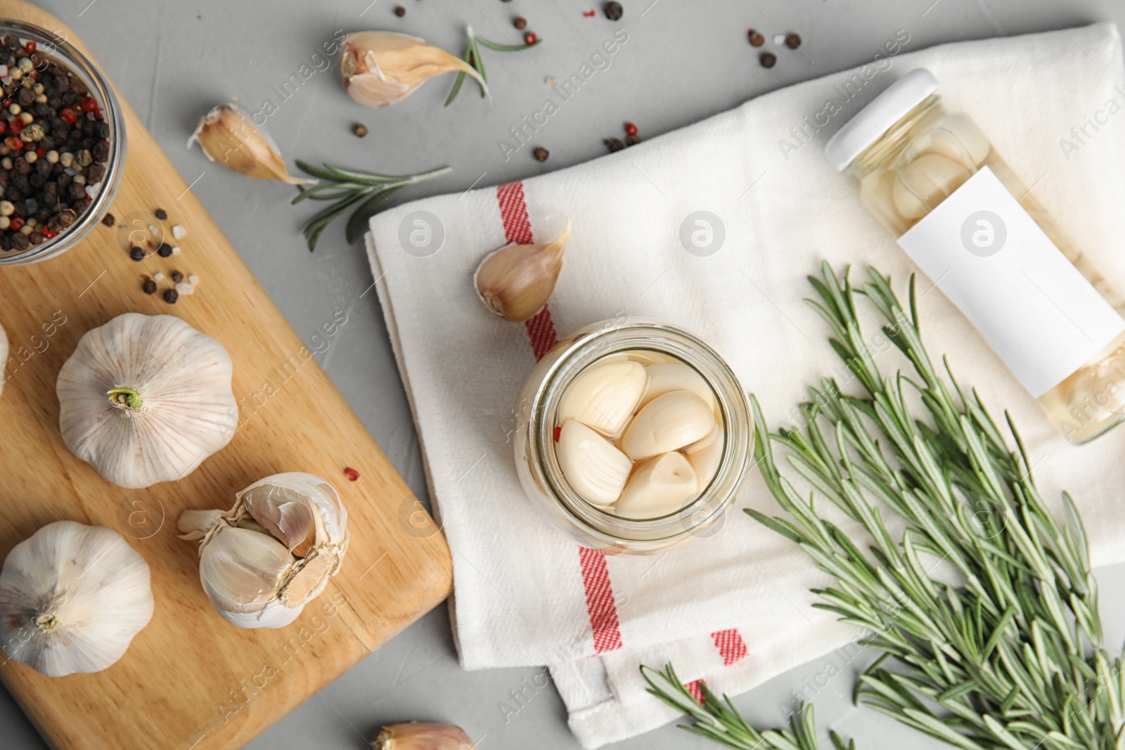 Photo of Flat lay composition with jar of pickled garlic on grey table