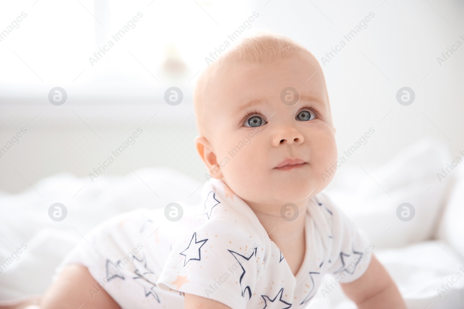 Photo of Portrait of cute little baby on blurred background
