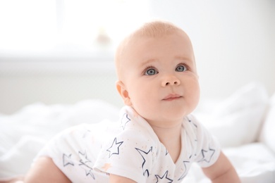 Photo of Portrait of cute little baby on blurred background