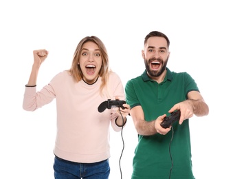 Emotional couple playing video games with controllers isolated on white