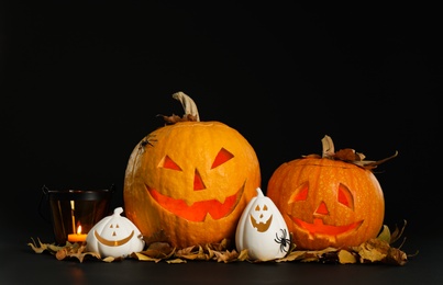 Composition with pumpkin heads on black background. Jack lantern - traditional Halloween decor