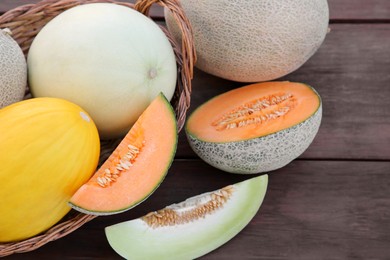 Photo of Tasty ripe melons on wooden table, above view