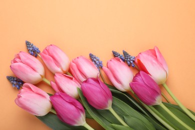 Photo of Beautiful different flowers on orange background, flat lay. Space for text