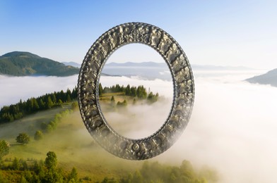 Image of Vintage frame and beautiful mountains covered with fog in morning