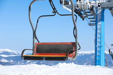 Photo of Empty chairlift at mountain ski resort. Winter vacation