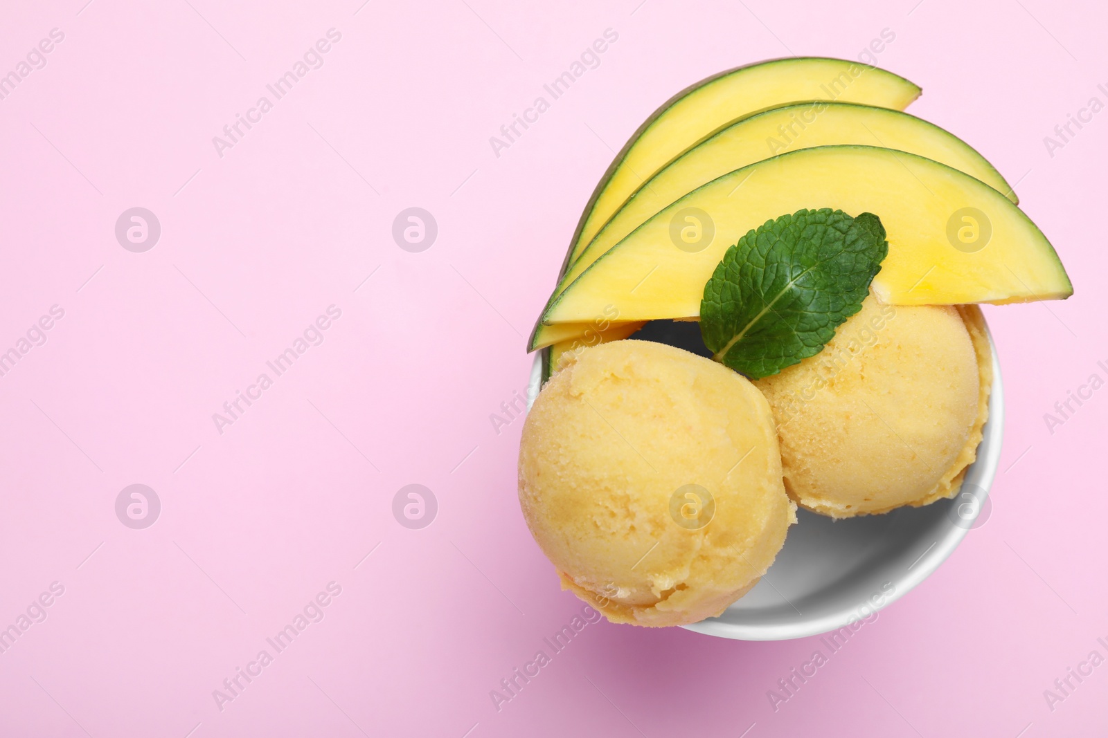 Photo of Delicious mango ice cream on pink background, top view. Space for text