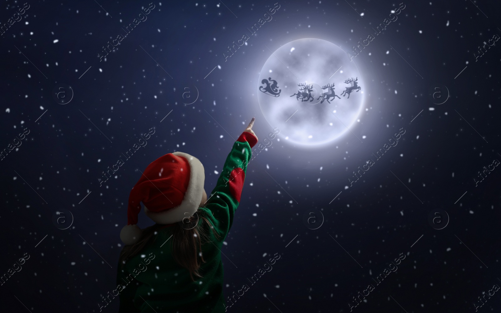 Image of Cute little girl looking at Santa Claus with reindeers in sky on full moon night. Christmas holiday