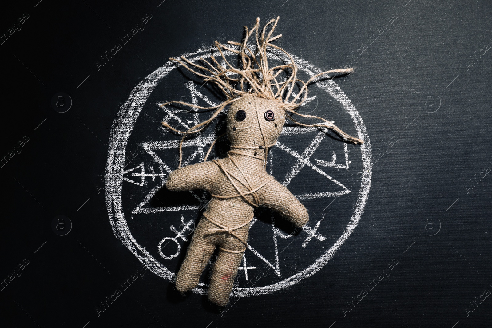 Photo of Female voodoo doll and runes on black background, top view
