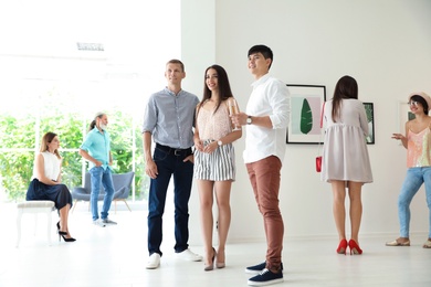 Group of people at exhibition in art gallery