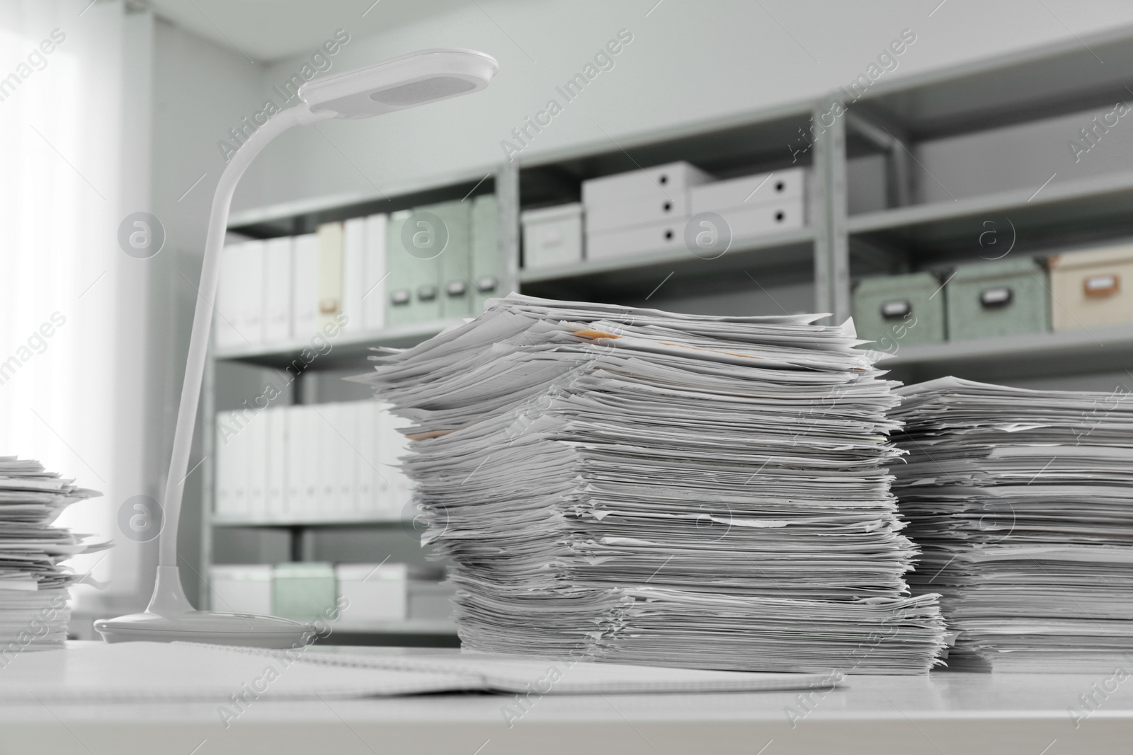 Photo of Stacks of documents on table in office