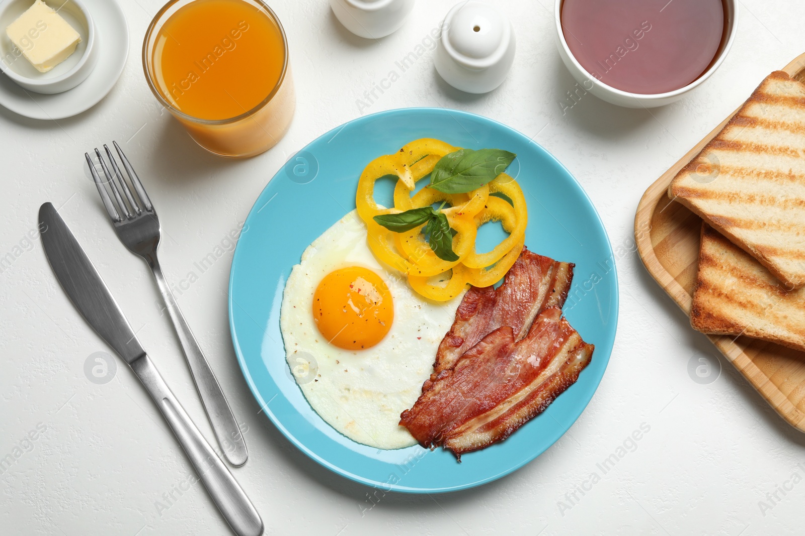 Photo of Tasty breakfast with fried egg served on light table, flat lay