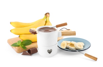 Fondue pot with chocolate and banana on white background