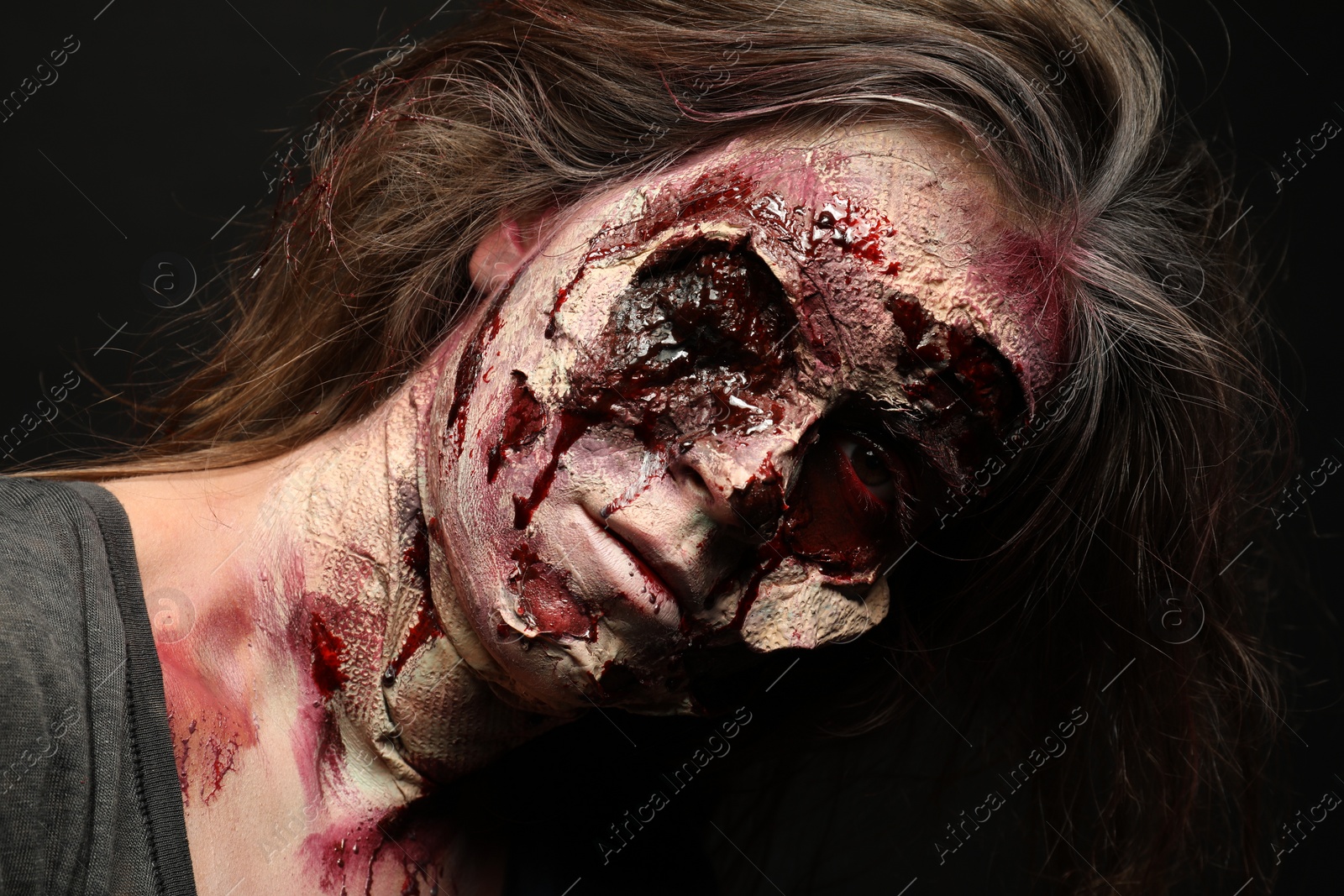 Photo of Scary zombie on dark background, closeup. Halloween monster