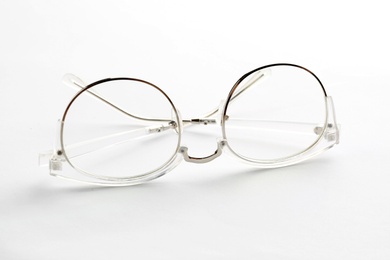 Photo of Glasses with corrective lenses on white background. Vision problem