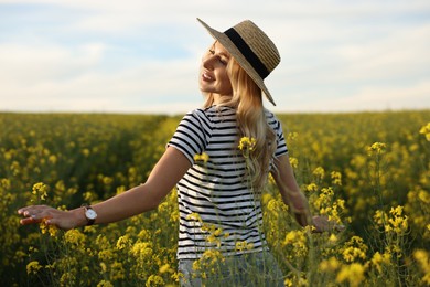Photo of Happy young woman with straw hat in field on spring day