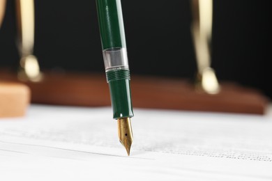 Signing notary document with fountain pen, closeup