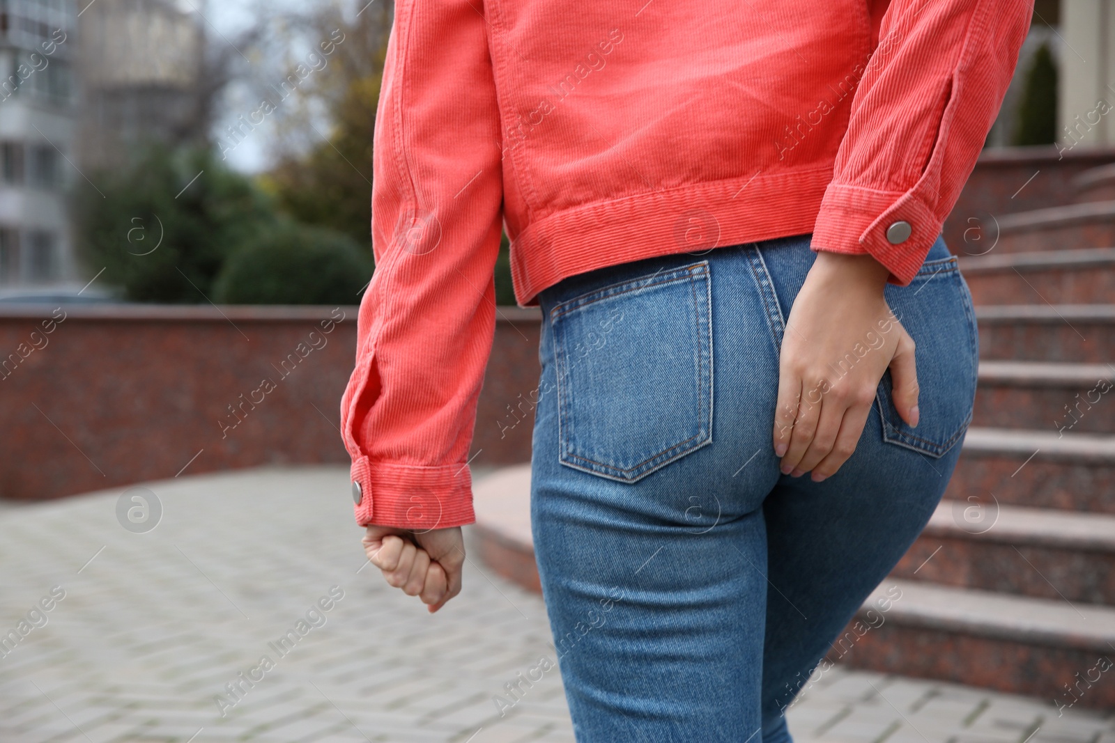 Photo of Woman suffering from hemorrhoid pain outdoors, closeup