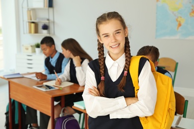 Teenage student in classroom. Stylish school uniform