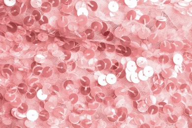 Beautiful pink fabric with shiny sequins as background, closeup