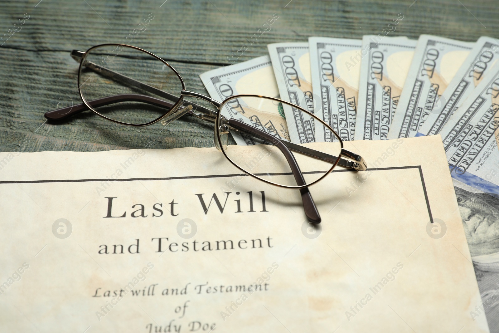 Photo of Last Will and Testament, glasses and dollar bills on rustic wooden table, closeup