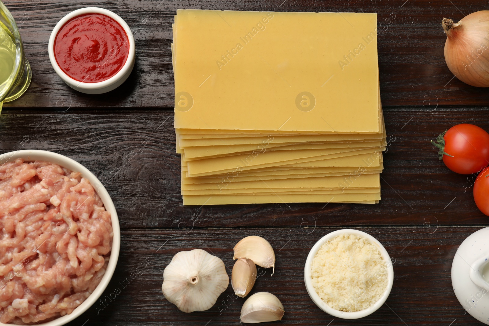 Photo of Ingredients for lasagna on wooden table, flat lay