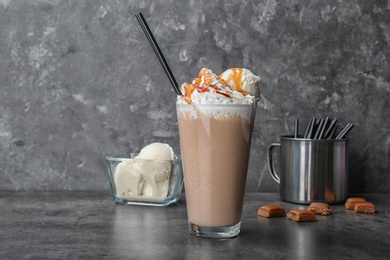 Photo of Glass with delicious milk shake on table