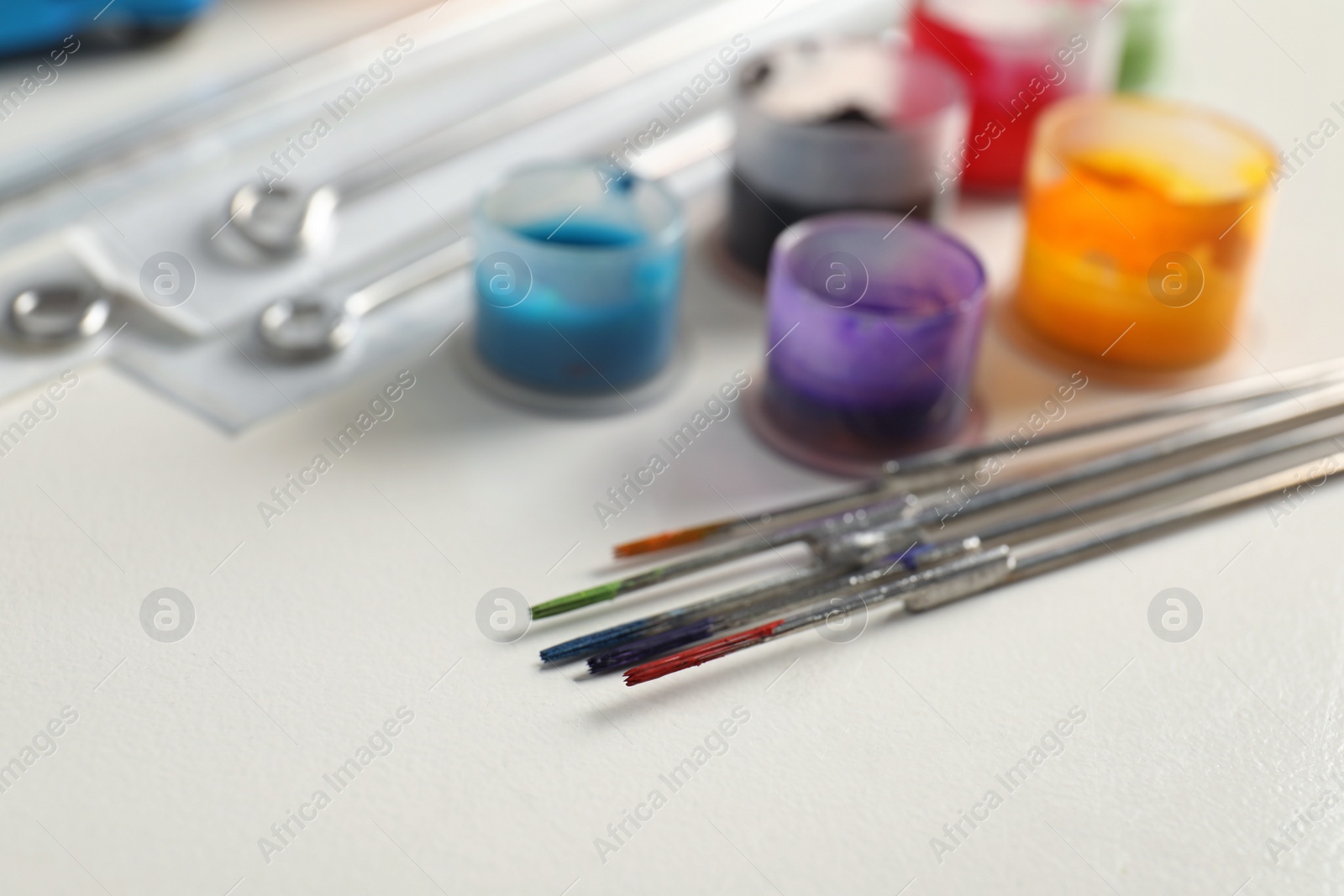 Photo of Composition with tattoo needles on white table