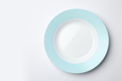 Clean empty plate on white background, top view