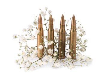 Bullets and beautiful gypsophila flowers isolated on white