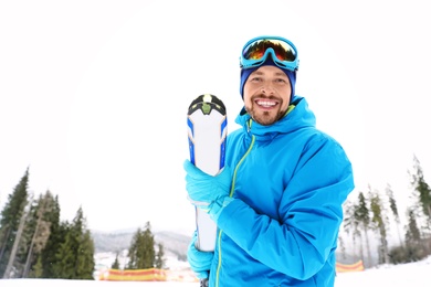 Male skier on slope at resort, space for text. Winter vacation