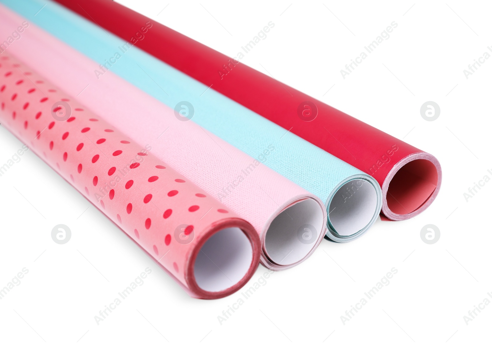 Photo of Rolls of colorful wrapping papers on white background