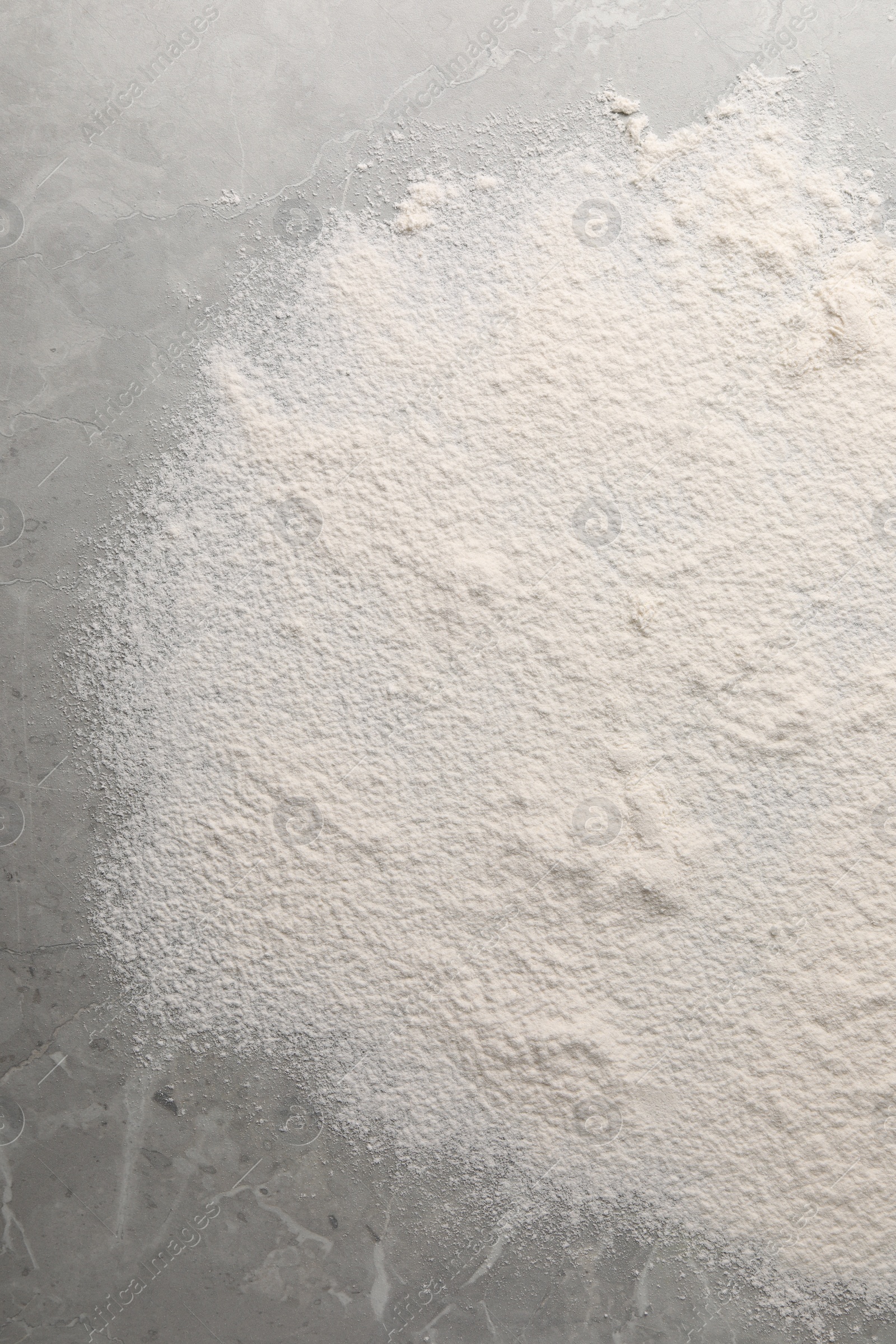 Photo of Pile of flour on grey marble table, top view