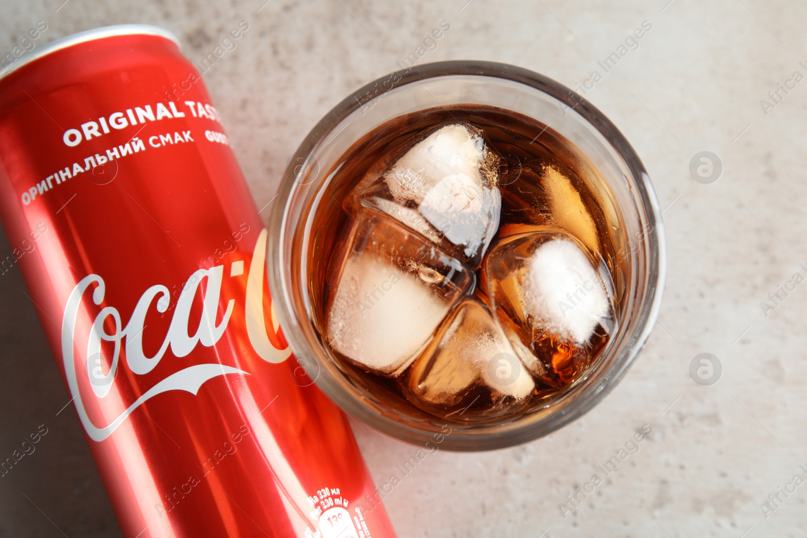 Photo of MYKOLAIV, UKRAINE - NOVEMBER 15, 2018: Glass and can with Coca Cola on table, top view