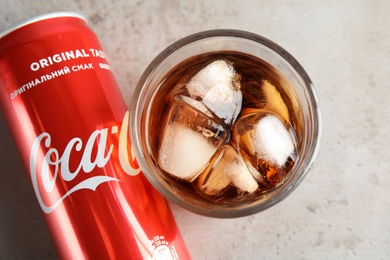 MYKOLAIV, UKRAINE - NOVEMBER 15, 2018: Glass and can with Coca Cola on table, top view