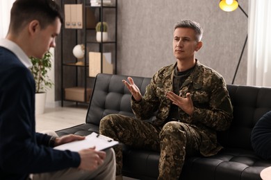 Professional psychotherapist working with military man in office