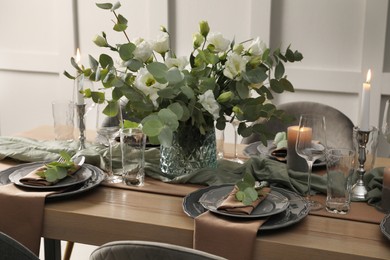 Photo of Festive table setting with beautiful floral decor indoors