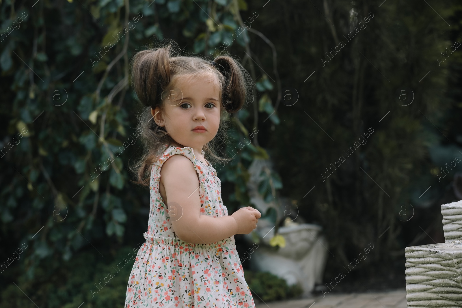 Photo of Cute little girl in park, space for text