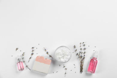 Flat lay composition with natural handmade soap and ingredients on white background. Space for text