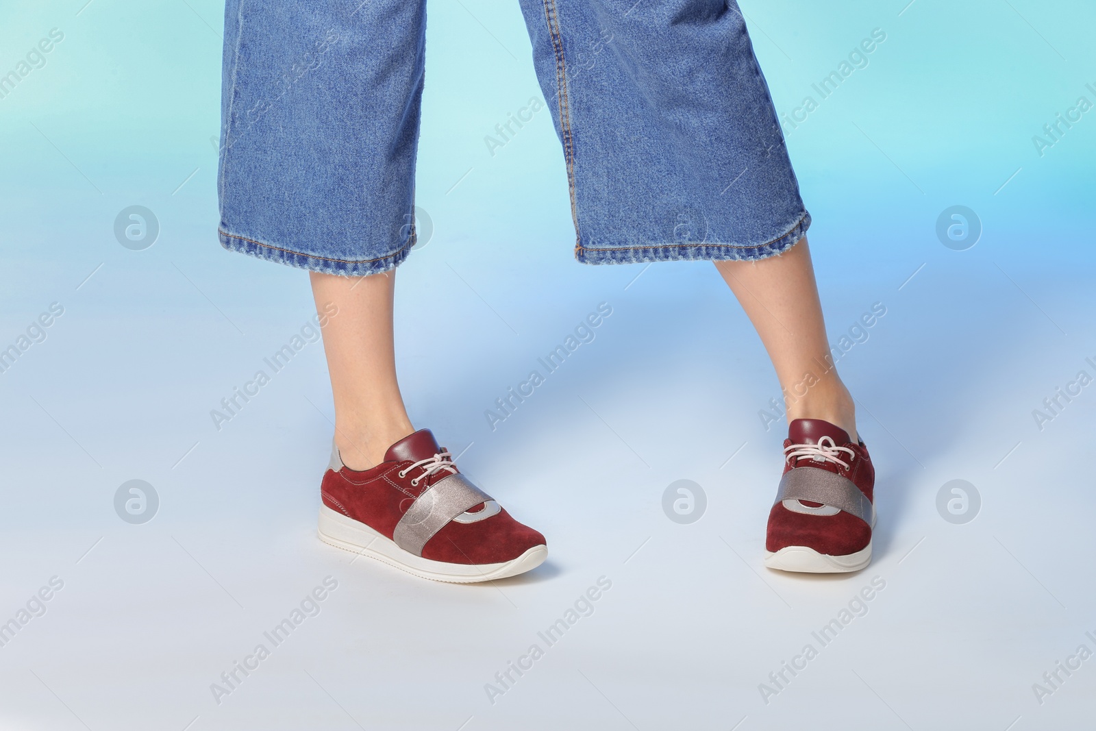 Photo of Woman in stylish shoes on color background, closeup