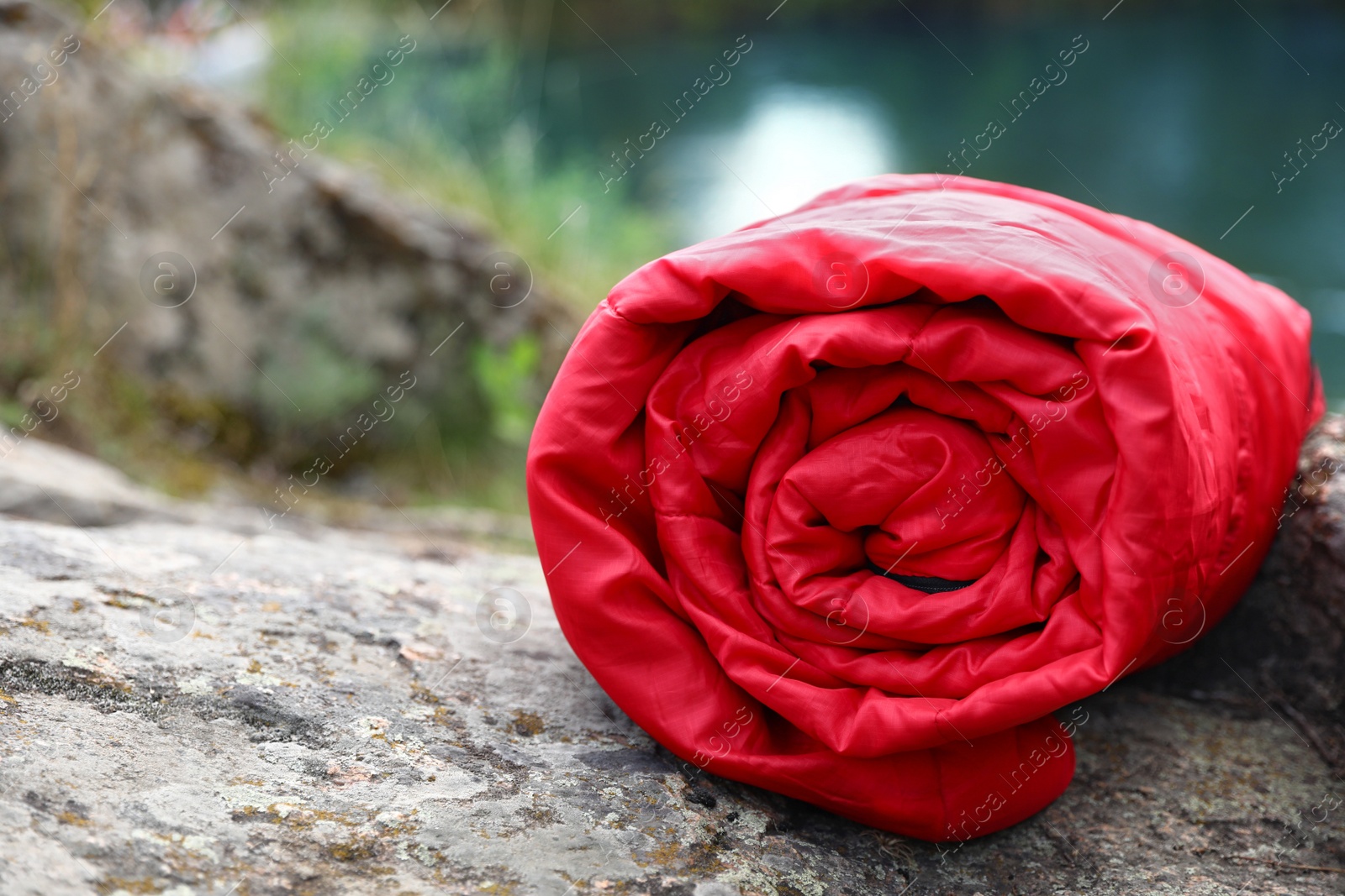 Photo of Rolled sleeping bag outdoors on sunny day