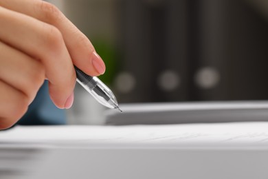 Woman signing document, closeup view. Space for text