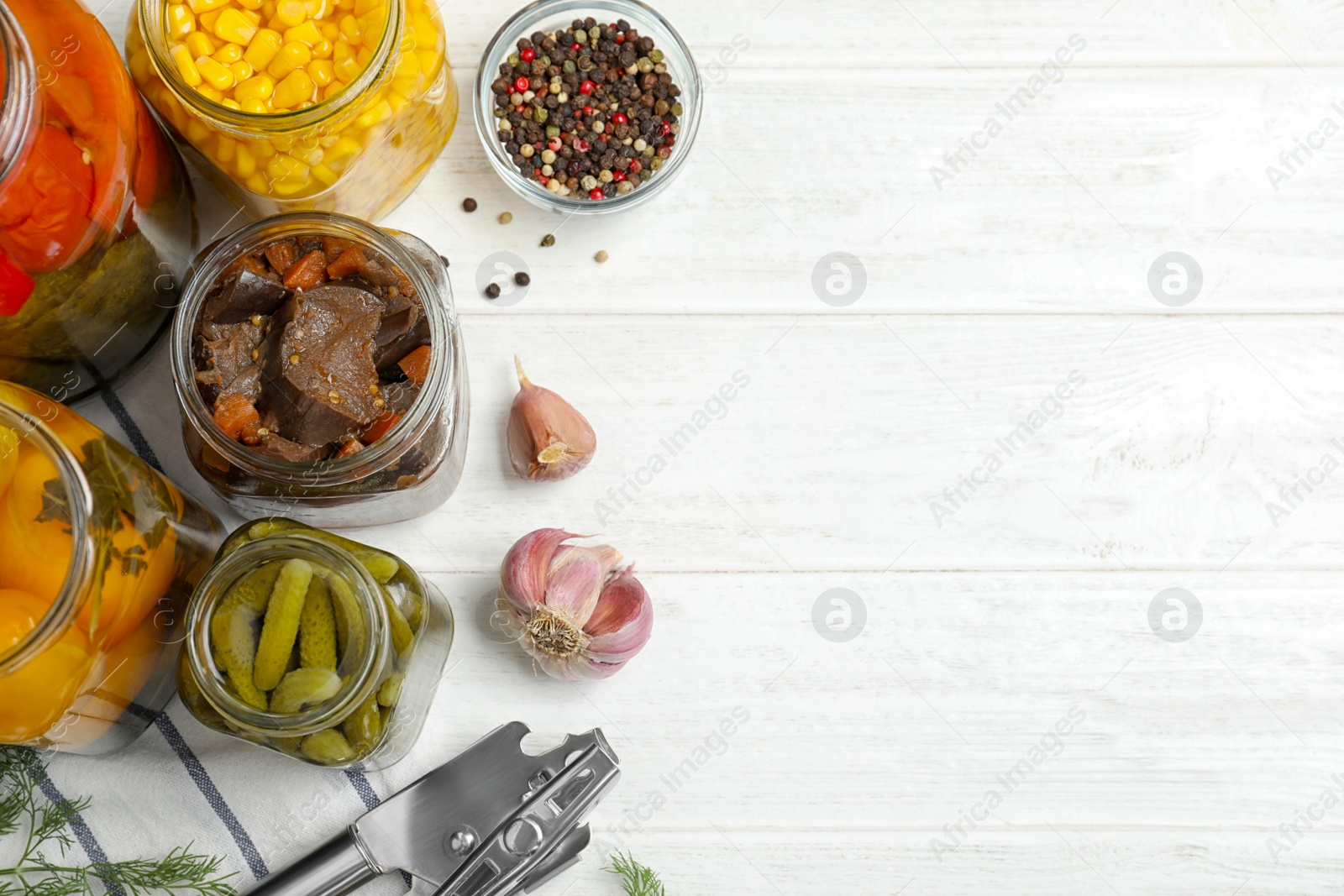 Photo of Jars with pickled vegetables on white wooden table, flat lay. Space for text