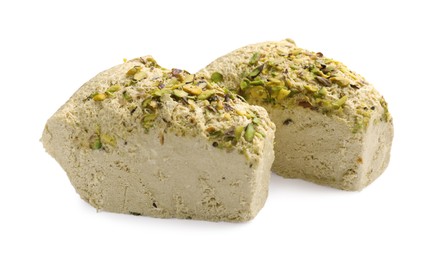 Photo of Pieces of tasty halva with pistachios on white background