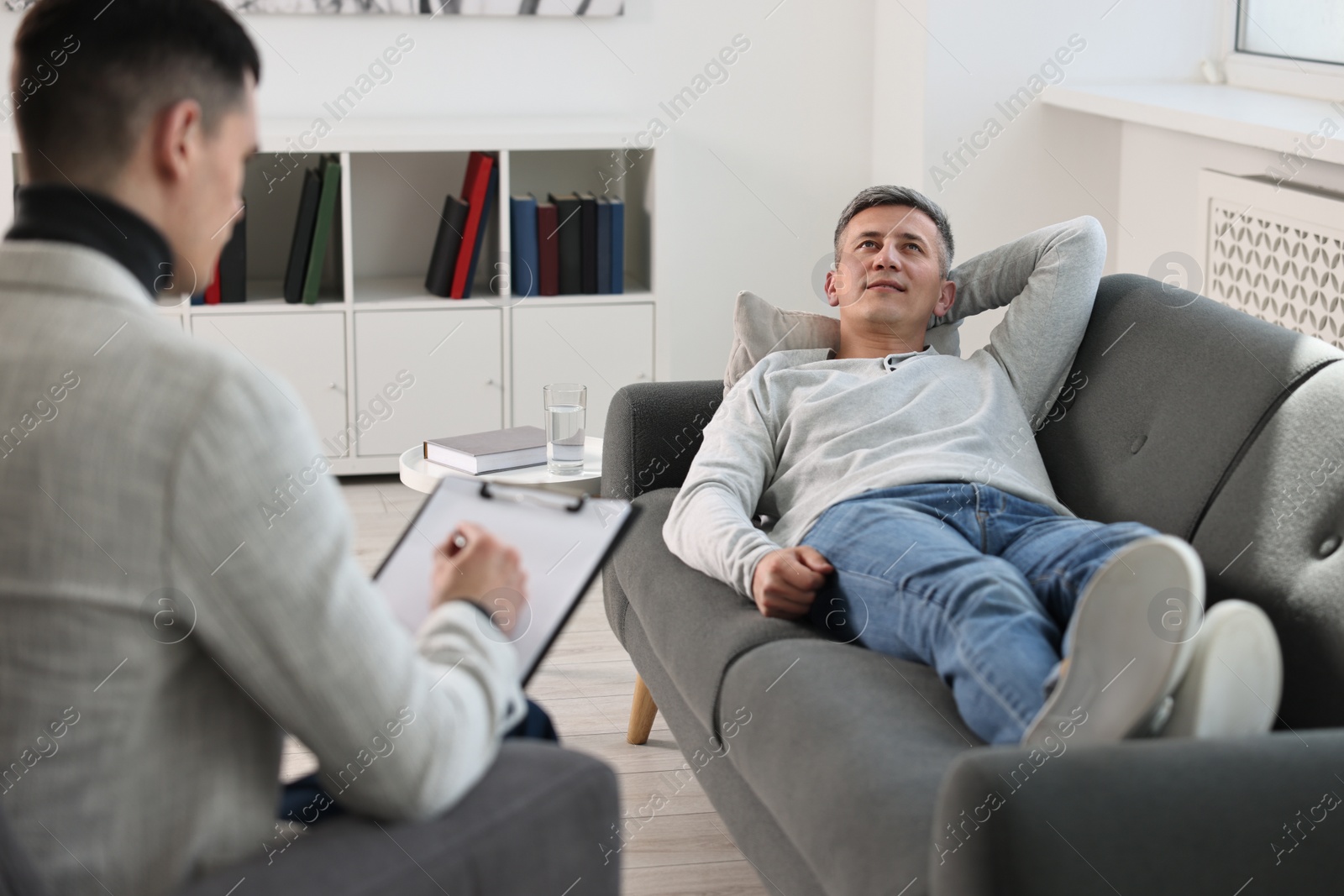 Photo of Professional psychotherapist working with patient in office