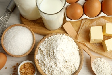 Photo of Fresh ingredients for delicious homemade cake on white wooden table