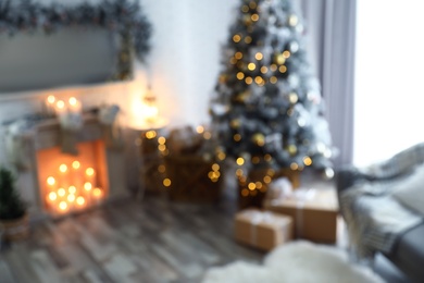Photo of Blurred view of beautiful Christmas tree in living room interior