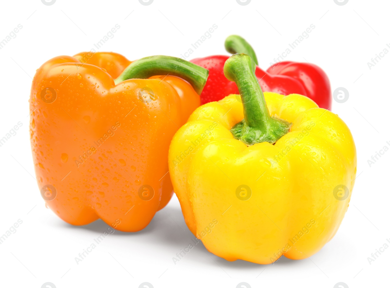 Photo of Wet ripe bell peppers on white background