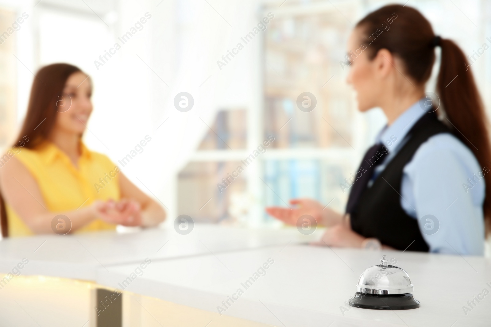 Photo of Service bell and female receptionist in hotel